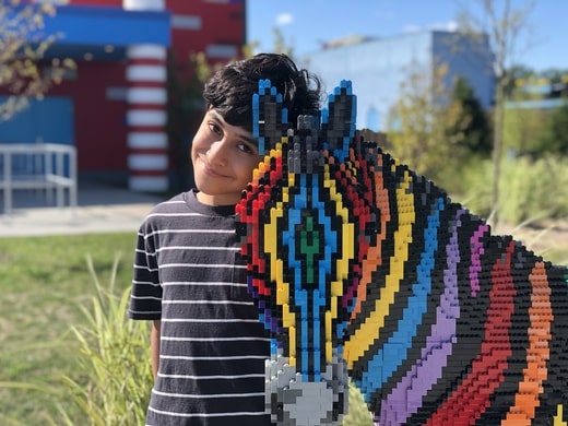 Mark with a rainbow-colored, lego zebra at legoland