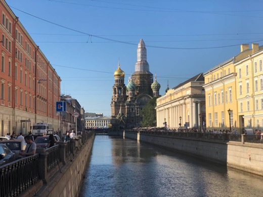 A canal leading to Saint Petersburg's Church of the Savior on Spilled Blood, visible under construction in the distance.